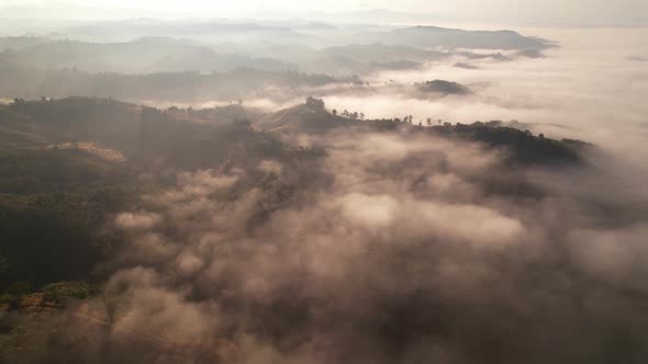 clouds above the valley and the mountains in the background. 4K Aerial video