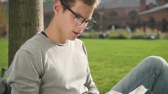 Lifestyle Shot of American Man Reading Book in Good Mood