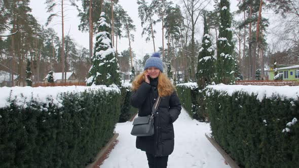 Smiling Woman Talking On Phone In Park