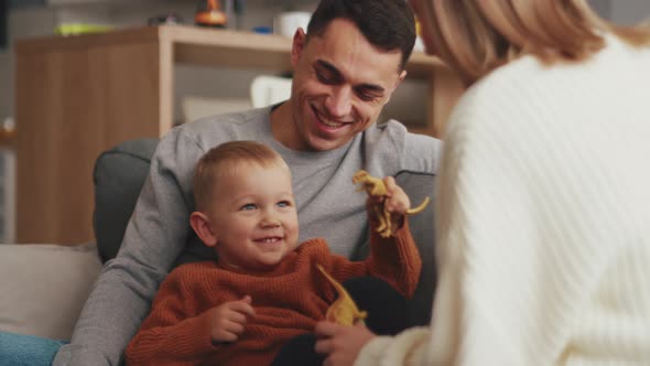 Smiling family playing on the sofa