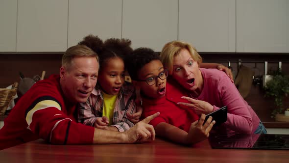 Happy Grandparents and Multiracial Children Posing for Selfie Shot Indoors