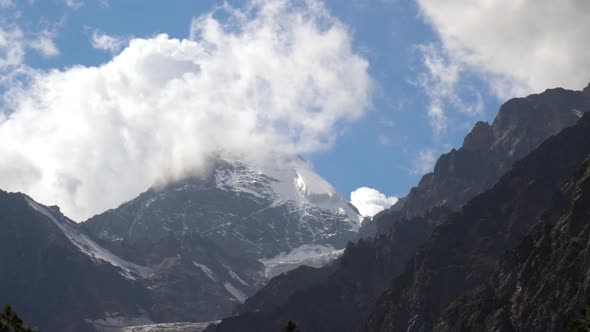 View of High Snowy Mountains with Clouds in the Sky.