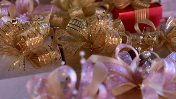 Close Up of Gift Boxes with Gold Ribbon Bow Decoration in Supermarket