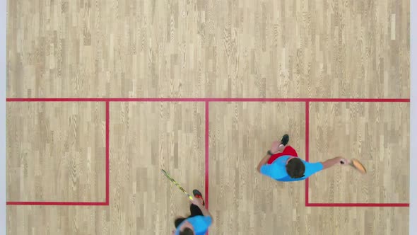 Top View of Two Men Competing in Squash in Gym. Adult Caucasian Sportsmen Playing Sport Game Indoors