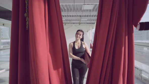 View of Young Woman Doing Pose of Antigravity Yoga in Studio