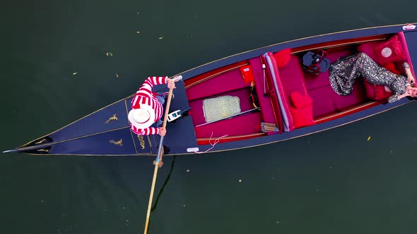 Luxury woman laying in gondola. Pretty girl travels in a boat in Venice. 