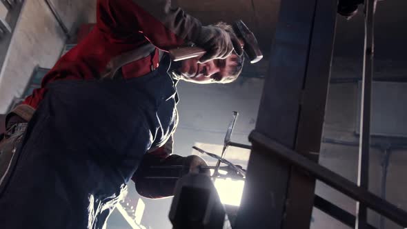 Man Blacksmith Hits Heated Detail Put in Sharp Clips and with a Hammer