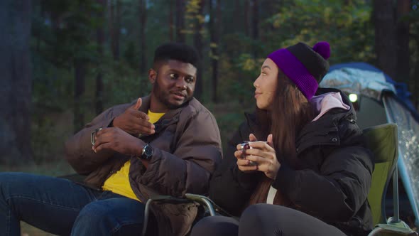 Multiethnic Hiking Couple Relaxing in Camping