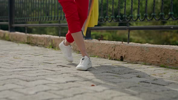 Joyful and Carefree Woman is Walking in City Closeup of Feet Jumping on Paving Stones