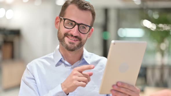 Portrait of Businessman Doing Video Call on Digital Tablet 