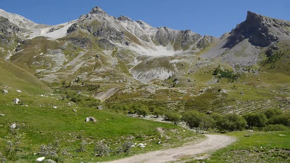 A man mountain biking across a European mountain range.