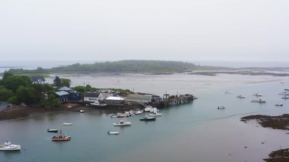 drone aerial of fishing and lobster boats sitting in marina 4k 30p