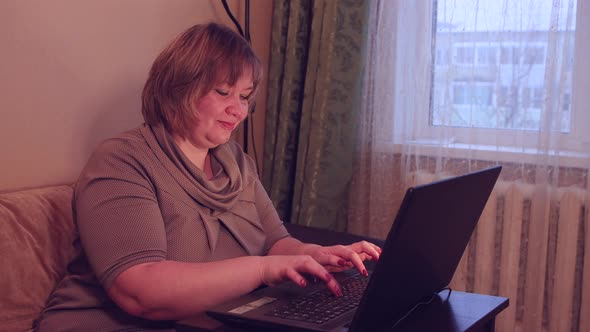 Young Woman Conducts Conference Calls on Laptop Studies Works From Home