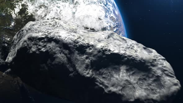an asteroid flies in outer space toward planet earth.