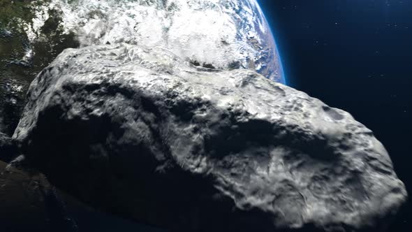 an asteroid flies in outer space toward planet earth. alt