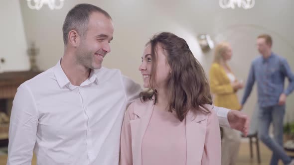 Portrait of Happy Caucasian Father and Daughter Looking at the Camera and Smiling. Mother and Son-in