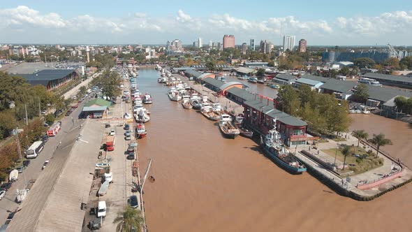 Aerial establishing shot rising over Puerto de Frutos in Tigre city near Buenos Aires