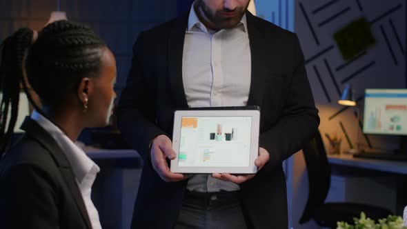 Focused Businessman Showing Corporate Graphs Presentation Using Tablet