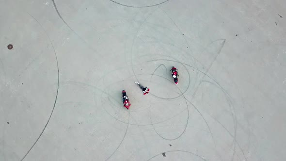 Top view of two professional bikers racing slowly in a circle way.