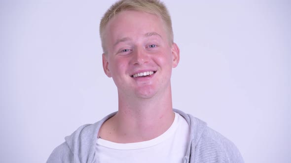 Face of Happy Young Blonde Man Smiling and Laughing