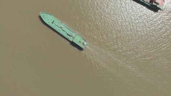 Aerial: cargo ship riding on the Mekong River Delta region, Can Tho, South Vietnam