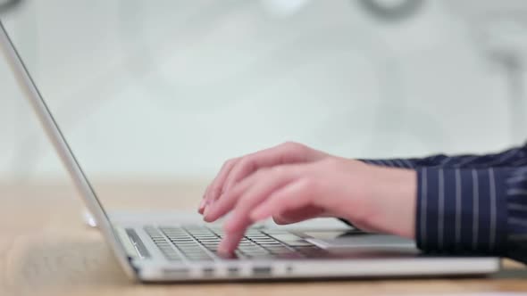 Side View of Businesswoman Typing on Laptop