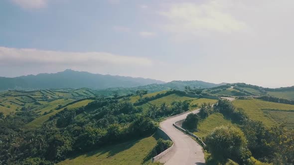 Cinematic aerial drone video of a roadline into a picturesque mountain view of Batanes in the Philip