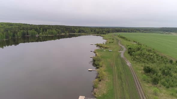 Aerial view of small lake with equipped fishing piers