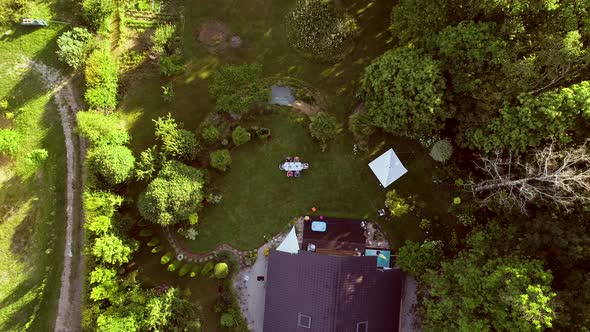 Aerial view of family at garden table for lunch.