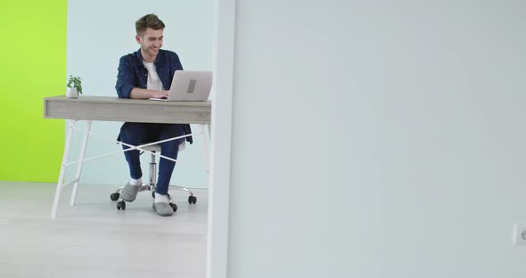 Freelance Career Smiling Man Working On Laptop Computer At Home