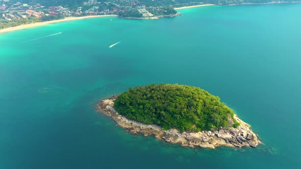 Nice rocks forested island, aerial panorama of Ko Pu against mountainous Phuket landscape on backgro