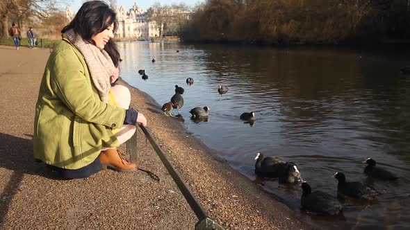 Happy asian young woman enjoying a sunny day at park in London