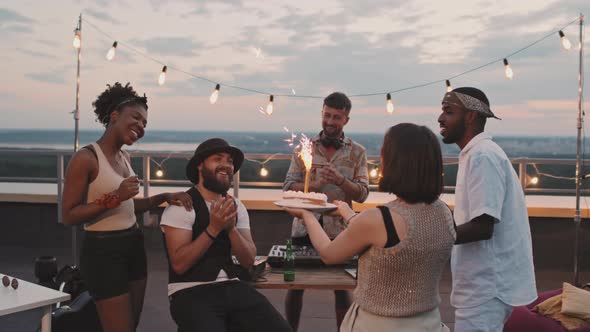 People Celebrating Friends Birthday on Rooftop Terrace