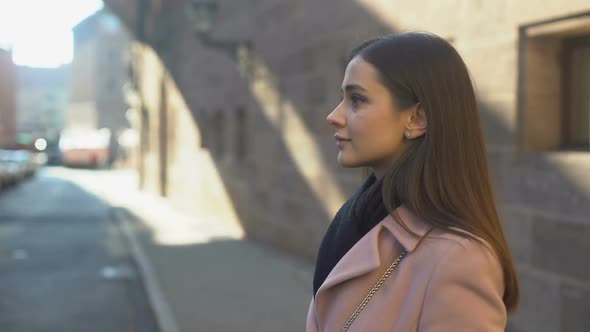 Young Pretty Stylish Female Waiting Taxi in Old City Center, Meeting Friends