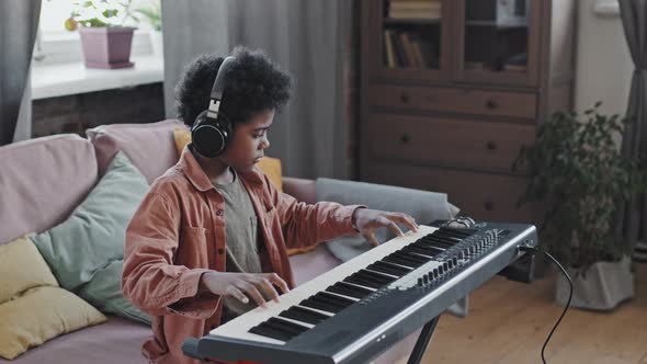 Little Boy Playing Synthesizer