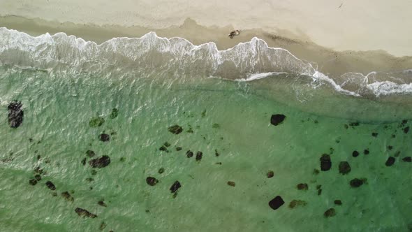 Aerial View of Rocky Beach and Sea Waves