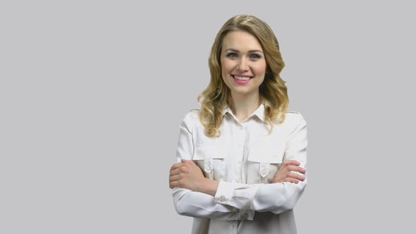 Portrait of a Young Happy Woman with Her Arms Crossed