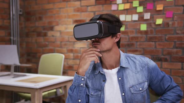 Creative businessman using virtual reality headset in modern office