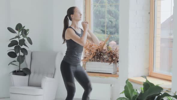 Young Fit Brunette Girl in Sportswear Does Sport Exercises at Home