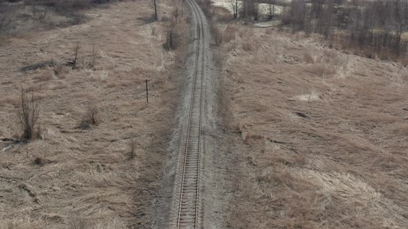 Descending on straight railroad track 4K aerial footage