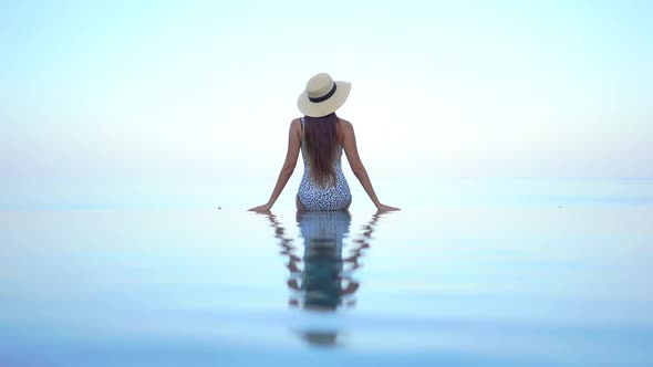 Young asian woman enjoy around outdoor swimming pool for leisure