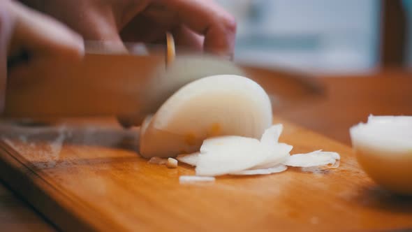 Woman Chef Sliced Onions on a Wooden Chopping Board in a Home Kitchen