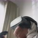 an Asian little girl with hijab playing a game wearing VR glasses - VideoHive Item for Sale