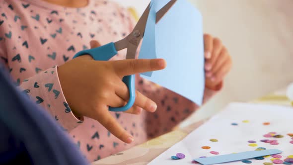 Toddler cutting with scissors and doing crafts