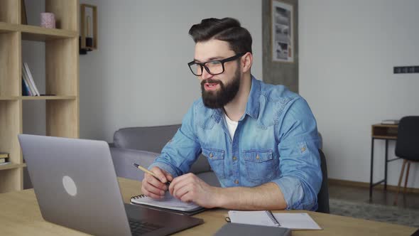 Smiling Male Employee Having Distant Business Negotiations Discussion on Laptop