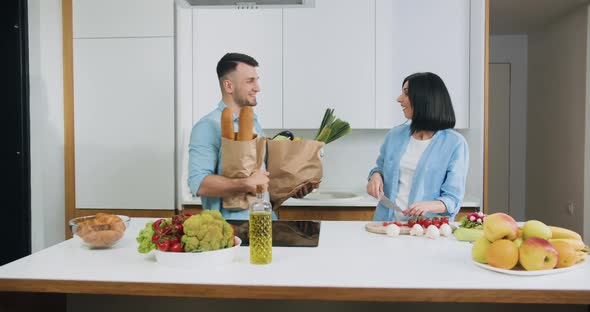 Married Couple which Having Fun Together During Cooking on Contemporary Cuisine