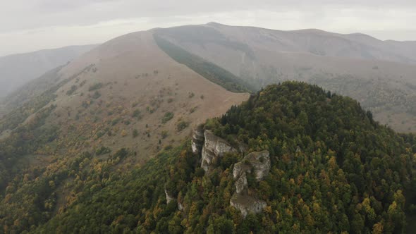 Aerial shot of rock formation on autumn forest peak, Slovakia