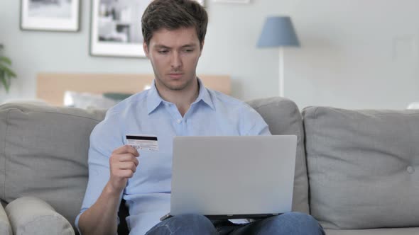 Handsome Young Man Shopping Online on Laptop