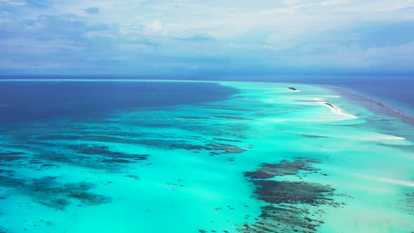 Tropical birds eye travel shot of a sandy white paradise beach and blue sea background in colourful 