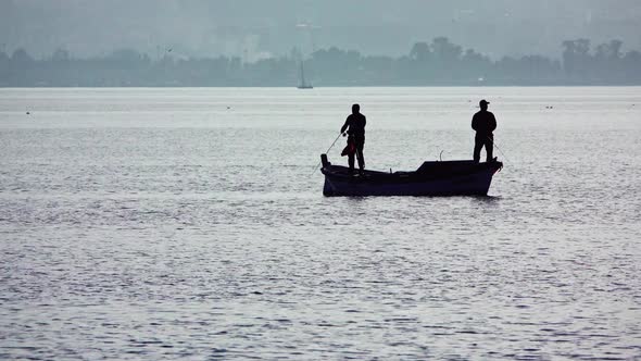 Fishermen Fishing With Rod Fishing On Old Fishing Boat